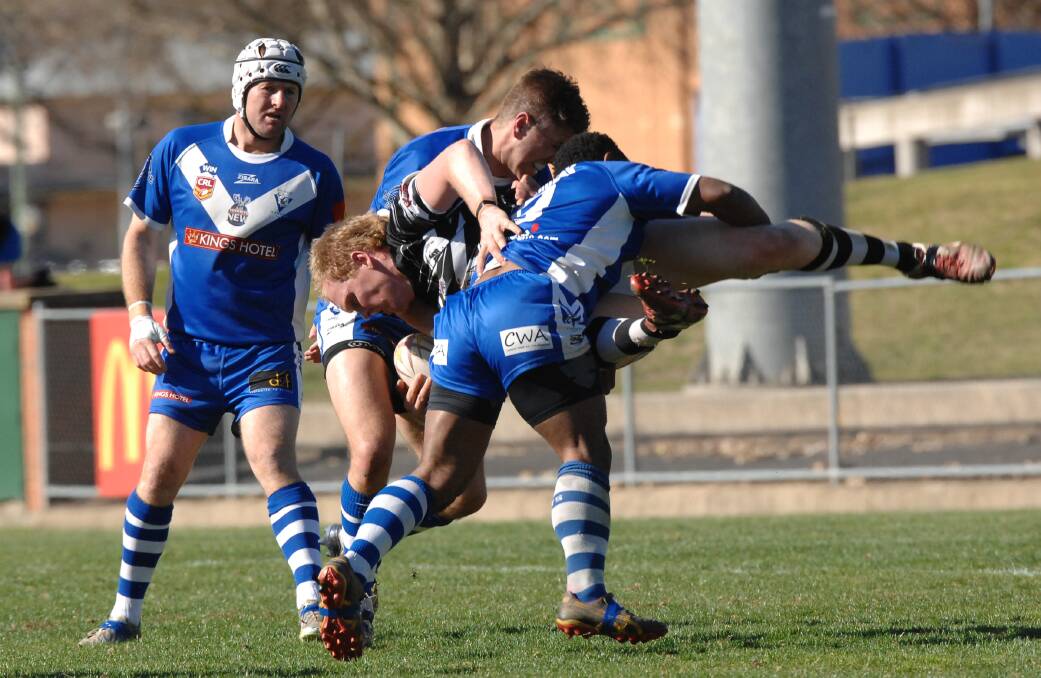 LACKLUSTRE: St Pat’s players Brent Dennis and Benjamin John go in for a tackle in yesterday’s 22-12 Group 10 Premier League major semi-final loss to the Cowra Magpies. Photo: ZENIO LAPKA	083114zleague1