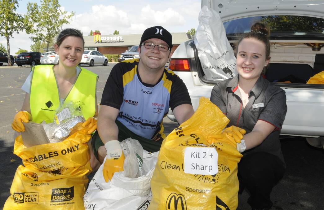 FILL THEM UP: McDonald’s Bathurst managers Cassandra McLeish, Rory Ferguson and Chloe Potts with rubbish collected on Clean Up Australia Day. Photo: CHRIS SEABROOK 	030115cleanup