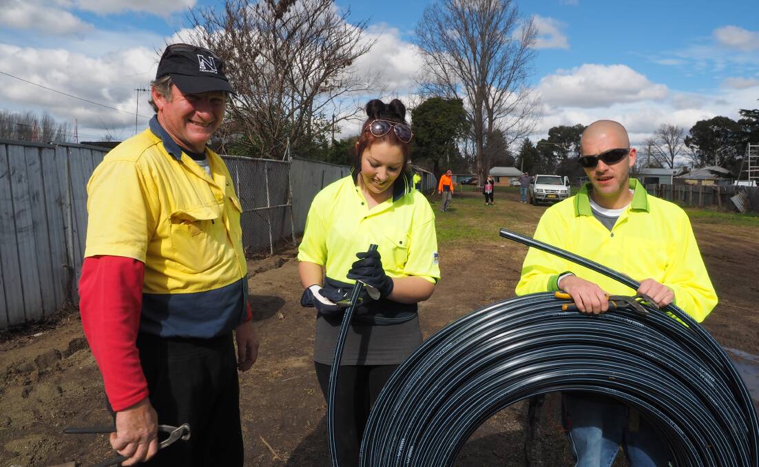 WORKING: Bathurst Building Maintenance owner Steve Sharwood and job-seekers Tamara Benger and Chris Ferris during a pilot program for job-seekers to undertake community service in return for their unemployment benefits. Photo: ZENIO LAPKA           072814zgarden
