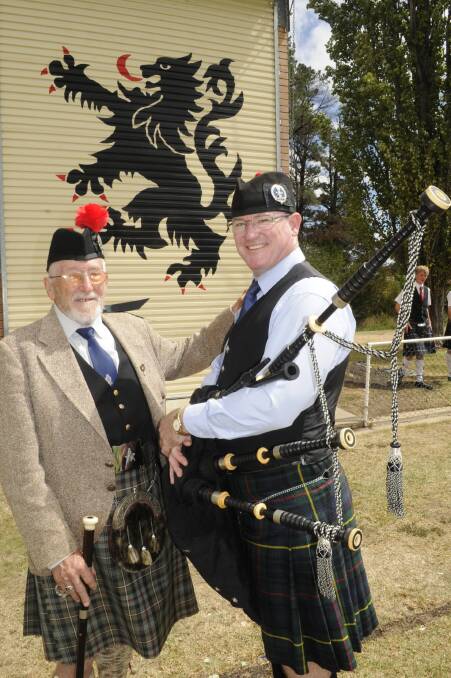 FAMILY TRADITION: John MacKenzie and his son Gill with their 200-year-old bagpipes that were played in the Battle of Waterloo on June 18, 1815. Photo: CHRIS SEABROOK 	032215cscots8