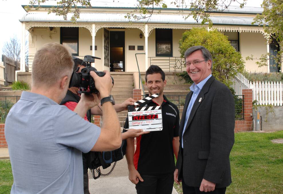 LIGHTS, CAMERA: Driver and part-time V8 presenter Michael Caruso interviews Bathurst mayor Gary Rush for V8 TV at Chifley Home yesterday as part of an upcoming short film series to be broadcast during the Bathurst 1000. The series will showcase many of Bathurst’s cultural attractions. Photo: ZENIO LAPKA 092414ztourism