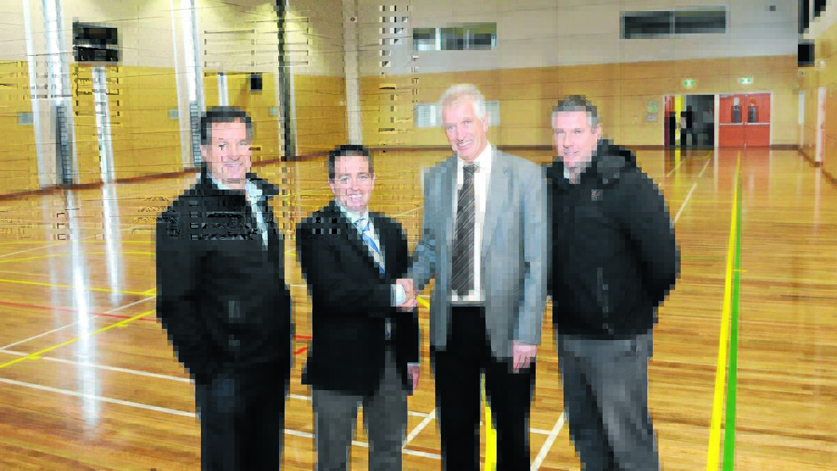 GRAND GYMNASIUM: Hines Construction managing director David Hines, Member for Bathurst Paul Toole,  Bathurst High School principal Geoff Hastings and Hines Construction site manager Simon McNamara in the new school gymnasium yesterday. Photo: PHILL MURRAY	062514phall2