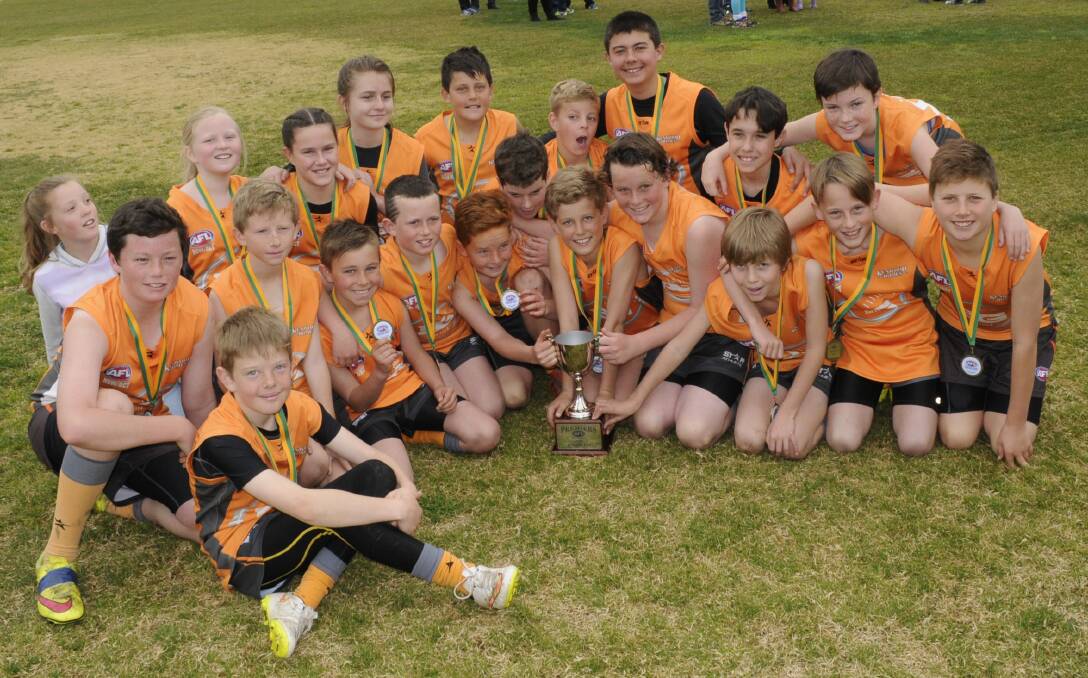 PROUD WINNERS: The Bathurst Giants under 12s side with the premiership trophy after their grand final win against Orange on Sunday. Photo: CHRIS SEABROOK 	082315cafl12s