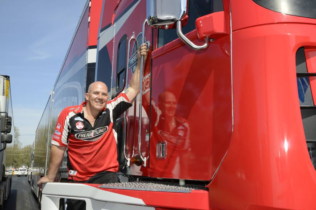 MAN AND HIS MACHINE: Truck driver Paul Eddy and his pride and joy, “Stax” the Team BOC/Freightliner Racing transporter, are in Bathurst for Race Week. Photo: PHILL MURRAY 100715pboc