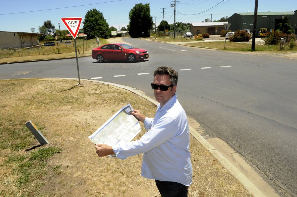 CROSSING PURPOSES: Lee Street business owner Jeff Clements would like to see the railway crossing remain open even after work on a Great Western Highway upgrade is completed. Photo: CHRIS SEABROOK 111814crossng