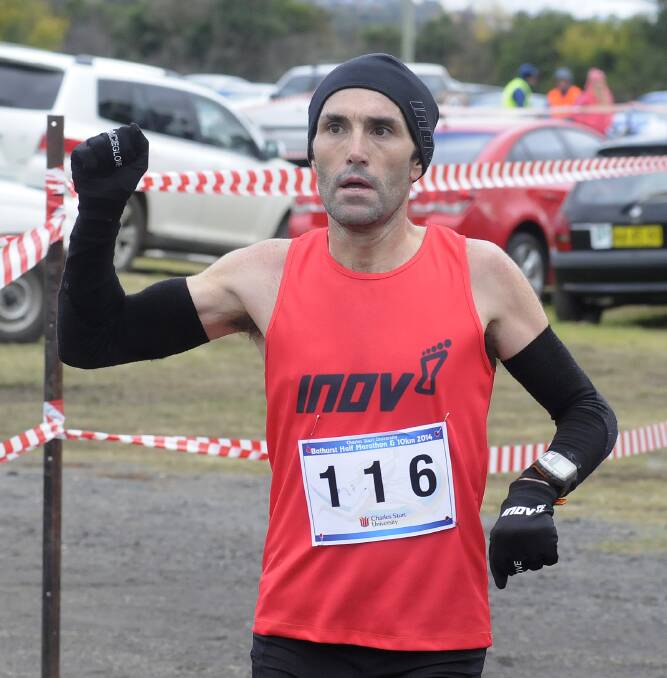 BACK TO BACK: Brendan Davies claimed his second straight Bathurst Half Marathon win yesterday, easily defeating his rivals despite the tough 
conditions.  Photo:  CHRIS SEABROOK  050414cmara1