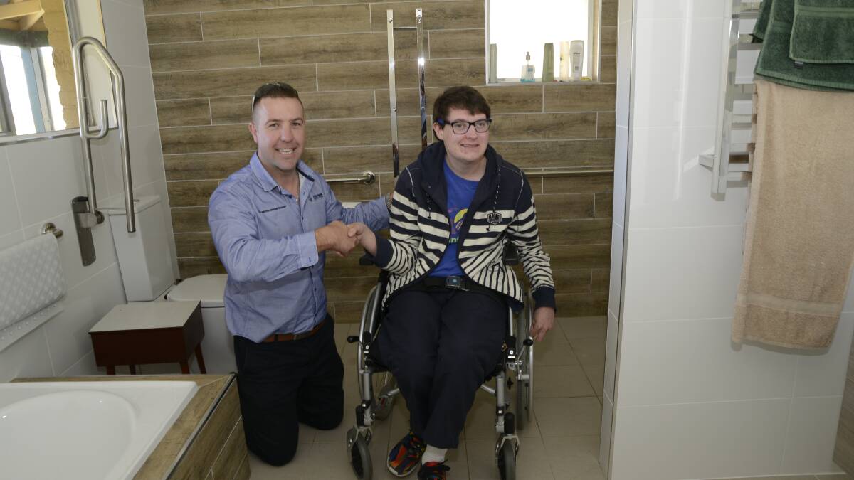 INDEPENDENCE DAY: Peter O’Brien and Liam White admire the new, roomy bathroom together. Photo: PHILL MURRAY 050616pliam1