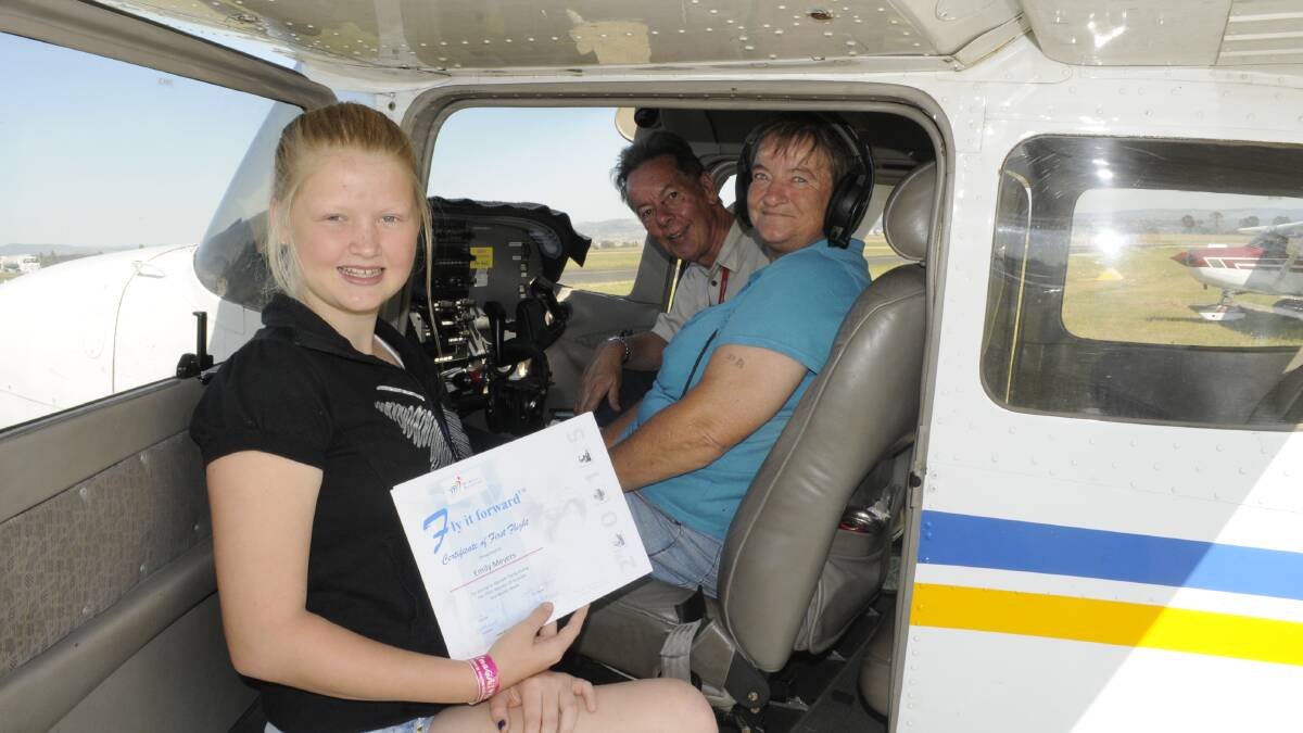 SKY HIGH: Emily Meyers, 13, with her grandmother Desley Meyers, 63, were among 100 women to take to the sky over Bathurst yesterday. They are pictured with chief flying instructor Chris Stott in a Cessna 172. Photo: CHRIS SEABROOK 030815cairprt3