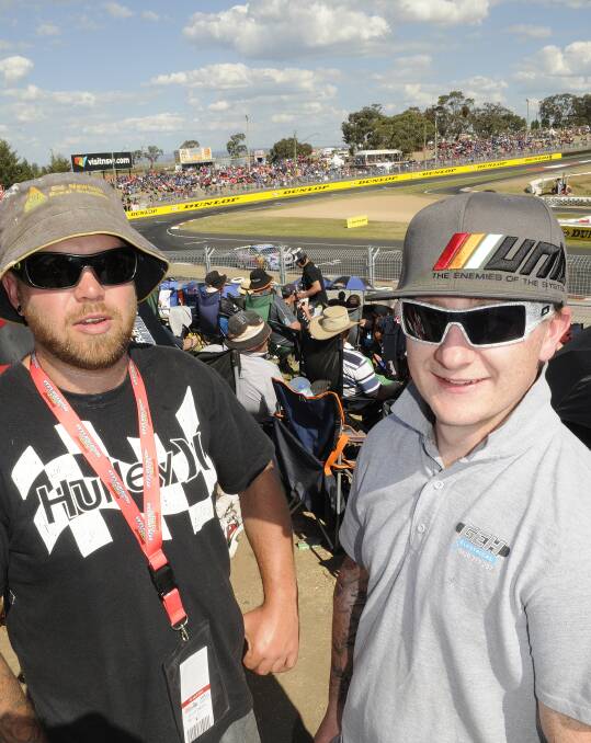 FENCE OFF: Race fans Chris Jaques and Matthew Harper, pictured at Murrays Corner, say new fencing around Mount Panorama might have been necessary, but it has created other problems. Photo: CHRIS SEABROOK 101214cfence1b