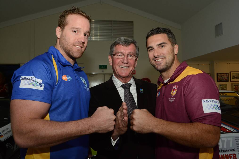 GRUDGE MATCH: City Police captain Mitch West (left) and Country Police captain Ben Wrigley with mayor Gary Rush at yesterday’s mayoral reception. Photo: PHILL MURRAY 	051915pfooty10