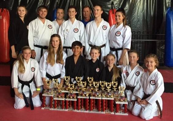 SUCCESS: There were plenty of top-three finishes for Warren Hickey’s Martial Arts Academy coaches and students (back row) Taylor Hickey (coach), Dale Thornberry, Jason Gay, Jordan Hickey, Warren Hickey (coach), Brodie Gay, Brittany Reece, (front row) Kiara Blattman, Felicity Hickey, Lewis Dunshea, Jaiden Gunning, Neesha Ward, Aaron Gay and Amber Gay at the ISKA World Cup last weekend.  102214hickey