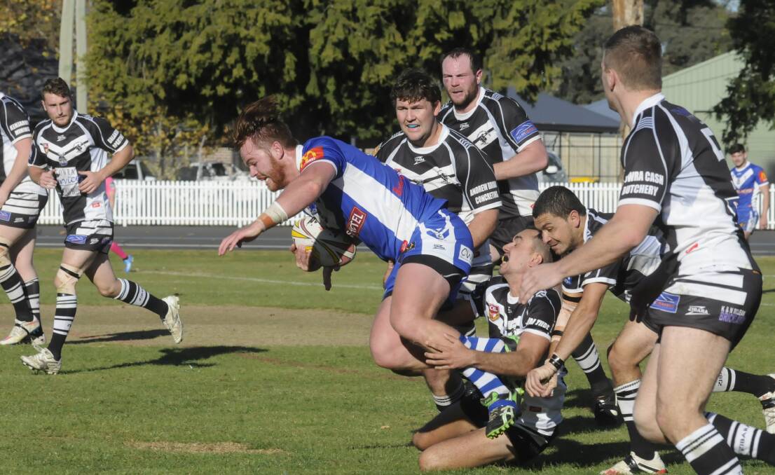 JUST ENOUGH: St Pat’s second rower Brady Cheshire gets wrapped up in yesterday’s 24-22 win over the Cowra Magpies at the Sportsground. Photo: CHRIS SEABROOK 051715cpats3