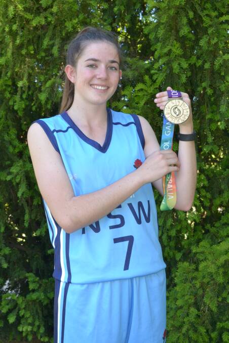 GOLDEN MOMENT: Bathurst basketballer Emily Matthews with the gold medal she earned with her NSW side at the recent Pacific School Games. Photo: ALEXANDER GRANT 120315agmatthews