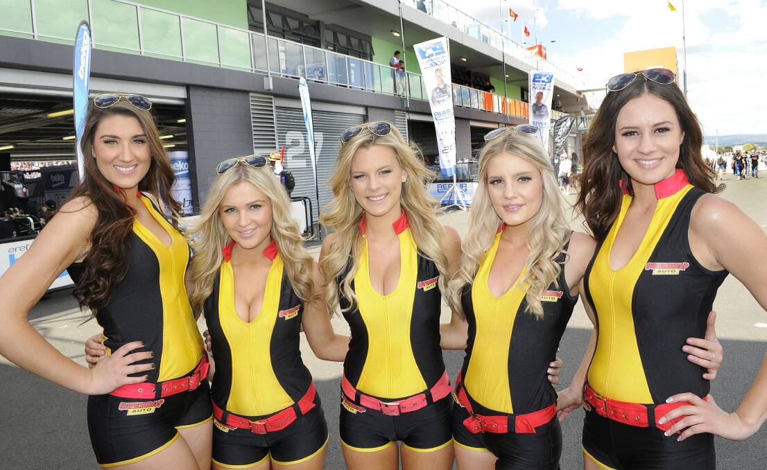 SMILE: The Supercheap Auto grid girls Abbye, Natalie, Bree, Kiara and Tatum would have to be among the most photographed people at Mount Panorama on the weekend. Photo: CHRIS SEABROOK 101214cv8girls
