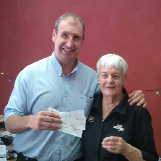 A MAMMOTH GESTURE: Steve Ellery presented Christmas Miracle Appeal co-ordinator Noela Sikora with a cheque for $5000 from the proceeds of the Charity Boxing Night on December 6. Photo: SUPPLIED 122414noela