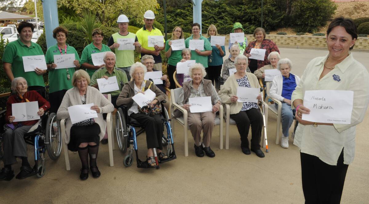 CAMPAIGN: Whiddon Group care services director Nicole Mahara with residents, staff, family members and workmen that took part in the Sign My Name campaign. Photo: CHRIS SEABROOK 031715cbrain1