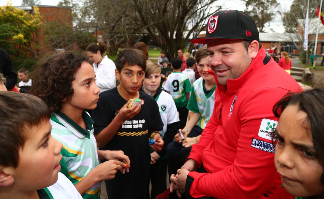 GORGEOUS GEORGE: Kids flock to NRL star George Rose during a visit to Kelso yesterday. Photo: PHIL BLATCH	 090315pbrose6