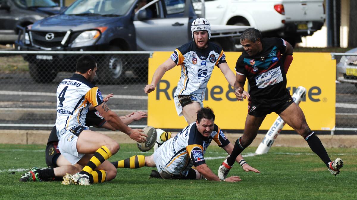 GOOD CHASE: Matt Woolmington (obscured) reaches out to score a try for Panthers during their last-gasp win over Oberon yesterday at Carrington Park. Photo: ZENIO LAPKA 062214zpan2