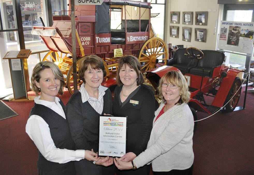 SHINING SILVER: Bathurst Visitor Information Centre staff Melinda Hadley, Trish Hays, Wendy Grundy and Karen Gould grinning with pride thanks to their tourism award win on the weekend. Photo: CHRIS SEABROOK 	072814csilver