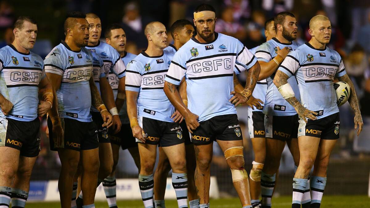The Sharks players look dejected after a Roosters try during the round seven NRL match between the Cronulla-Sutherland Sharks and the Sydney Roosters at Remondis Stadium on April 19, 2014 in Sydney, Australia. Photo: Mark Nolan/Getty Images.