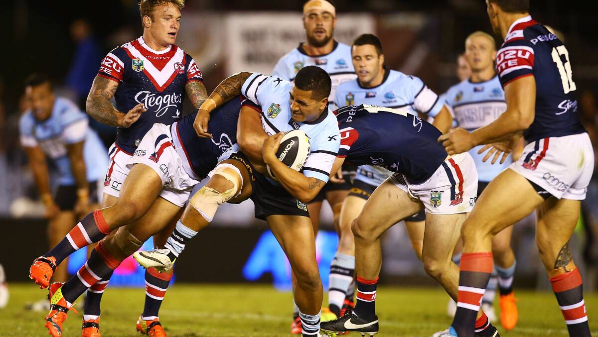  Sosaia Feki of the Sharks is tackled during the round seven NRL match between the Cronulla-Sutherland Sharks and the Sydney Roosters at Remondis Stadium on April 19, 2014 in Sydney, Australia. Photo: Mark Nolan/Getty Images.