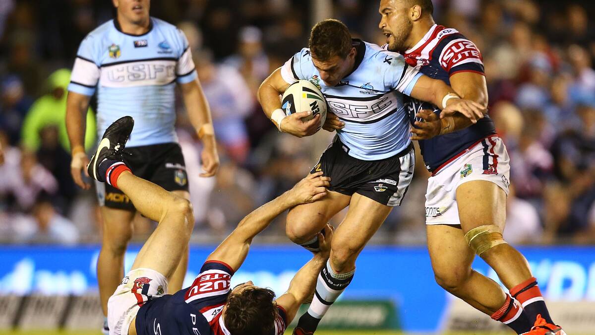 John Morris of the Sharks is tackled during the round seven NRL match between the Cronulla-Sutherland Sharks and the Sydney Roosters at Remondis Stadium on April 19, 2014 in Sydney, Australia. Photo: Mark Nolan/Getty Images.