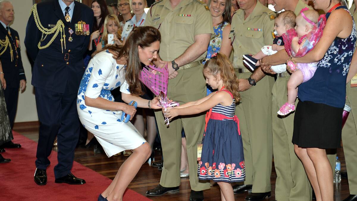 Catherine, Duchess of Cambridge receives flowers from Tahila McCabe as the Duke and Duchess of Cambridge visit RAAF base Amberley on April 19, 2014 in Brisbane, Australia. The Duke and Duchess of Cambridge are on a three-week tour of Australia and New Zealand, the first official trip overseas with their son, Prince George of Cambridge. Photo: Anthony Devlin - Pool/Getty Images.