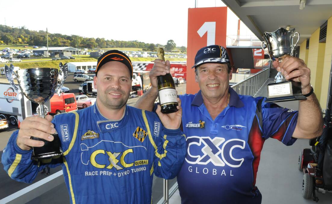 Bathurst Motor Festival: Dylan and David Thomas, who won the NSW  Production Touring Cars race with their trophies and a bottle of  wine.They drove a Mitsubishi Evo X  (Car no 68). 