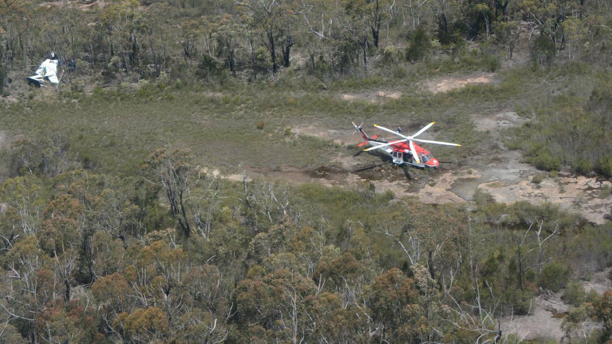 The Ambulance Rescue helicopter at the scene of Thursday's plane crash north of Nerriga. The photo was taken from the Australian Maritime Safety Authority Dornier search and rescue aircraft.