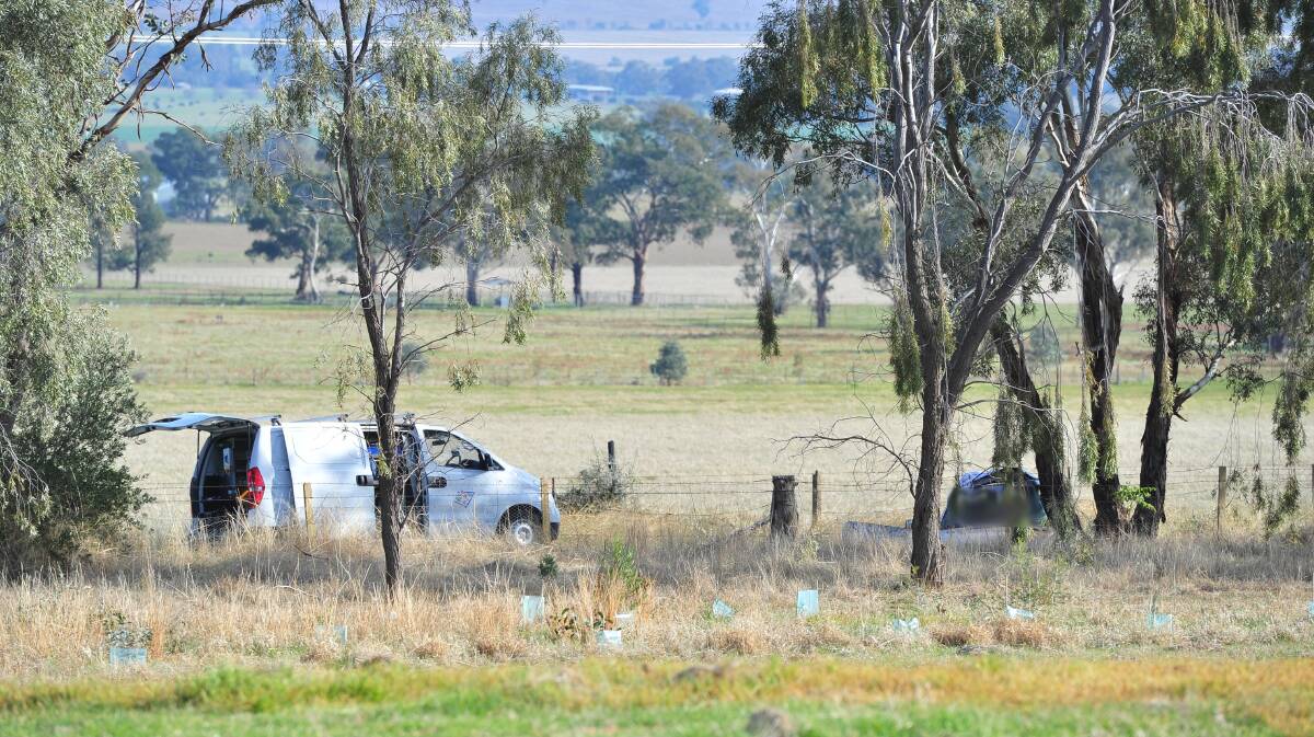 Investigators at the scene of a fatal car crash near Wagga Wagga that left a Dubbo man dead and another teen in a serious condition. 				     Photo: KIEREN L TILLY