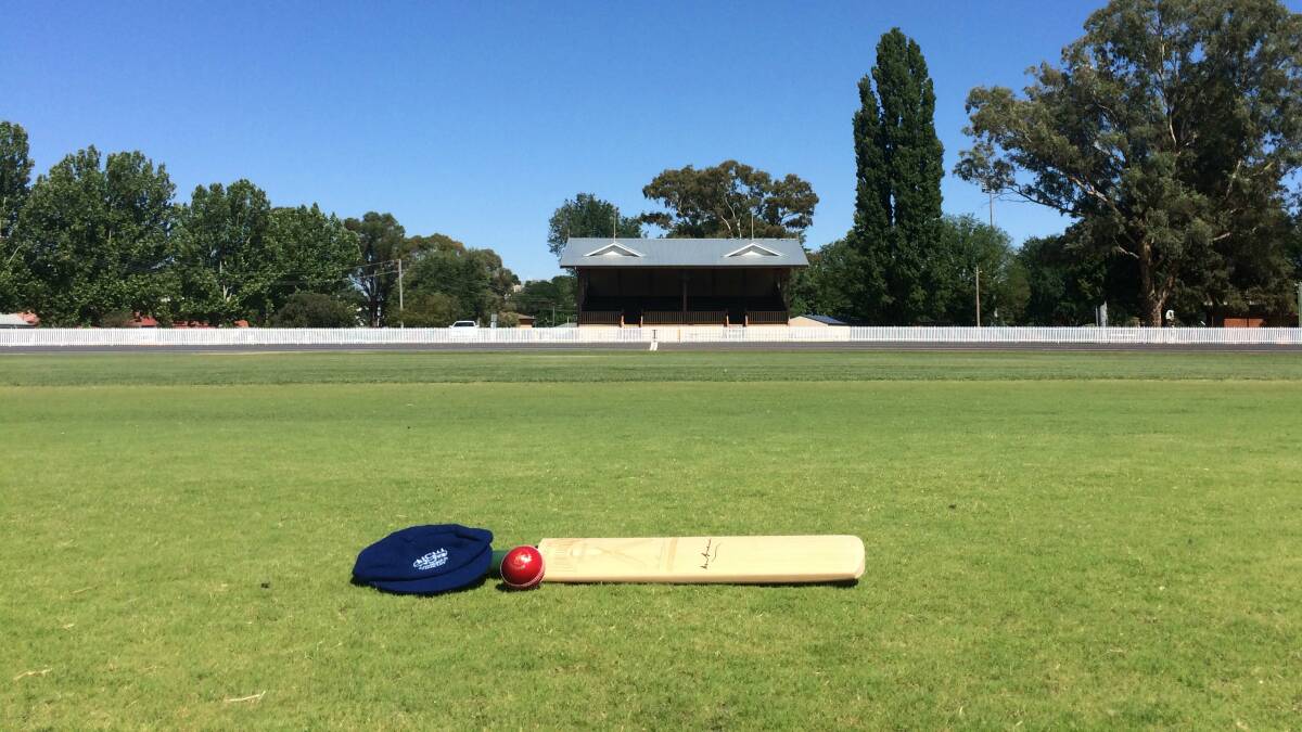 A lone cricket bat personally signed by Sir Donald Bradman, a NSW Combined Country cap and a shiny new six-stitcher sit in the centre wicket area of the Bathurst Sportsground. 
