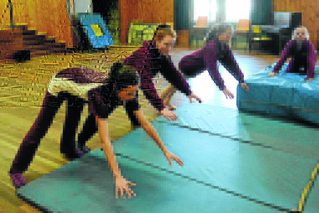 NEW PROGRAM: Learning to fall at West Bathurst Public School’s circus class were Sarah Lane, Bobbie-Lee Tobitt and Sophie Thomas. 081815pwest