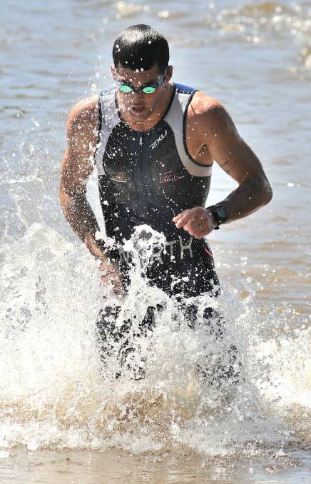 ONE DOWN, TWO TO GO: Bathurst triathlete Nick North emerges from Lake Canobolas after completing the swim leg of the first race in the Central West Inter-Club Triathlon Series. Photo: Steve Gosch 1123sgtri3