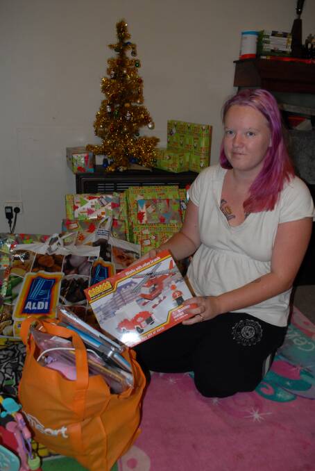 THANK YOU EVERYONE: Kiara White with presents donated by the community for her children after thieves broke into her house on Sunday and stole the presents she had bought. Photo: ZENIO LAPKA 122414zchristmas