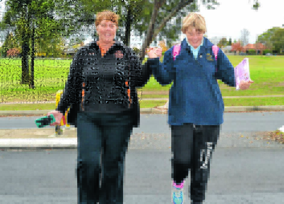STILL HOPING FOR A CROSSING: Leanne Crean and daughter Georgie Stair cross Browning Street outside Carenne Public School during Walk Safely to School Day. Photo: LOUISE EDDY 52215leroad3