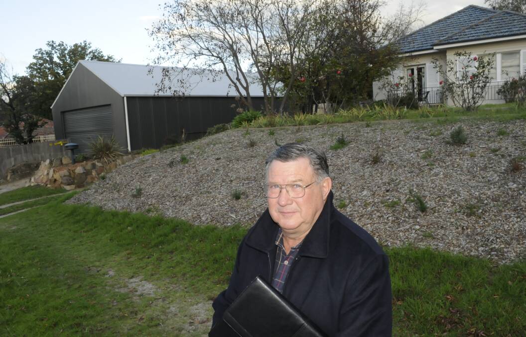 CALL FOR REVIEW: National Trust Bathurst branch chairman Iain McPherson with the Mitre Street shed. Photo: CHRIS SEABROOK 051215cshed