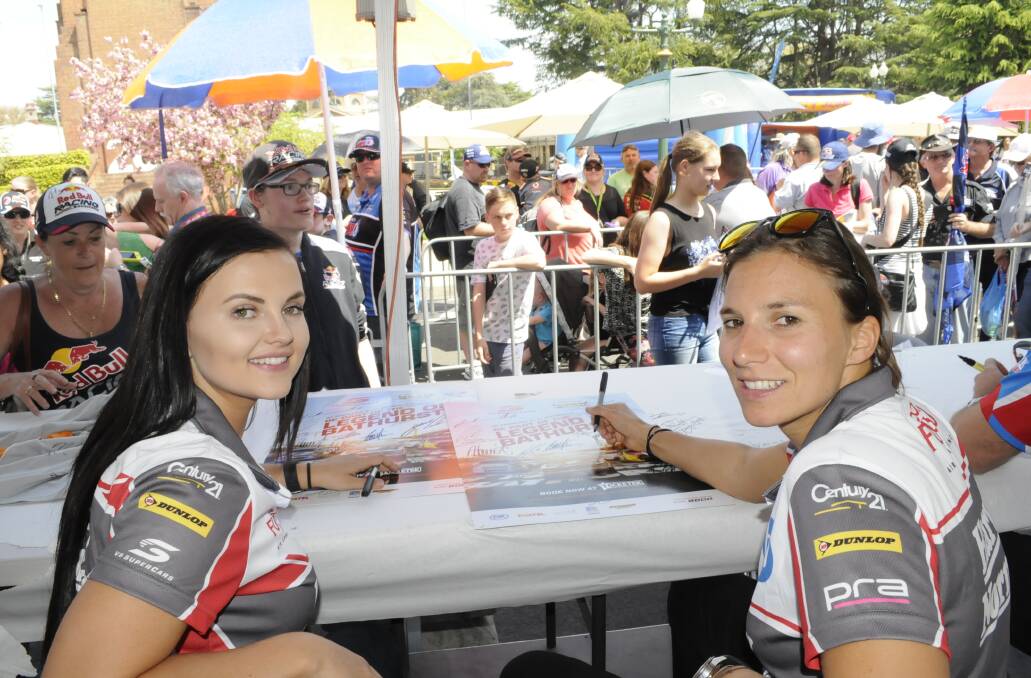 SUPER GIRLS: V8 Supercars drivers Renee Gracie and Simona de Silvestro are the first all-female team in almost 20 years to tackle iconic Mount Panorama. They had lots of fans at yesterday’s driver signing session in Kings Parade. Photo: CHRIS SEABROOK 100715cgirls1a
