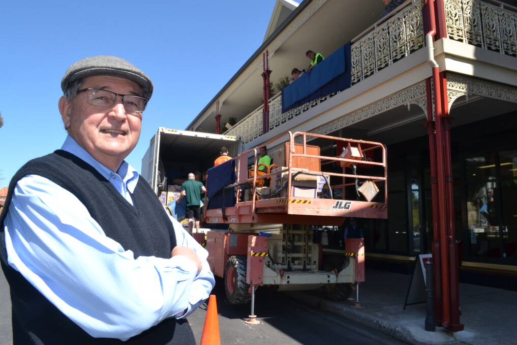 ON THE MOVE: Developer Bruce Bolam keeps a close eye on his much-loved antique furniture as it is hoisted into his new upstairs unit in George Street. Photo: BRIAN WOOD 092314bruce