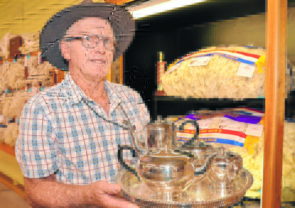 NOSTALGIA: Wool producer Brian Seaman with the silver service tea set won by his forebears for the top commercial value fleece at the 100th Royal Bathurst Show in 1968.  Photo: ZENIO LAPKA  041715zshow-1-35