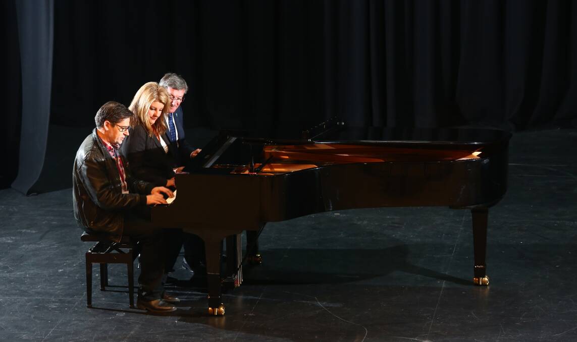  A KEY PURCHASE: Mitchell Conservatorium executive director Graham Sattler, Bathurst Eisteddfod Society president Paula Elbourne and Bathurst mayor Gary Rush christen City Hall’s new grand piano with their own version of Chopsticks. Photo: PHIL BLATCH 082615pbpiano3    