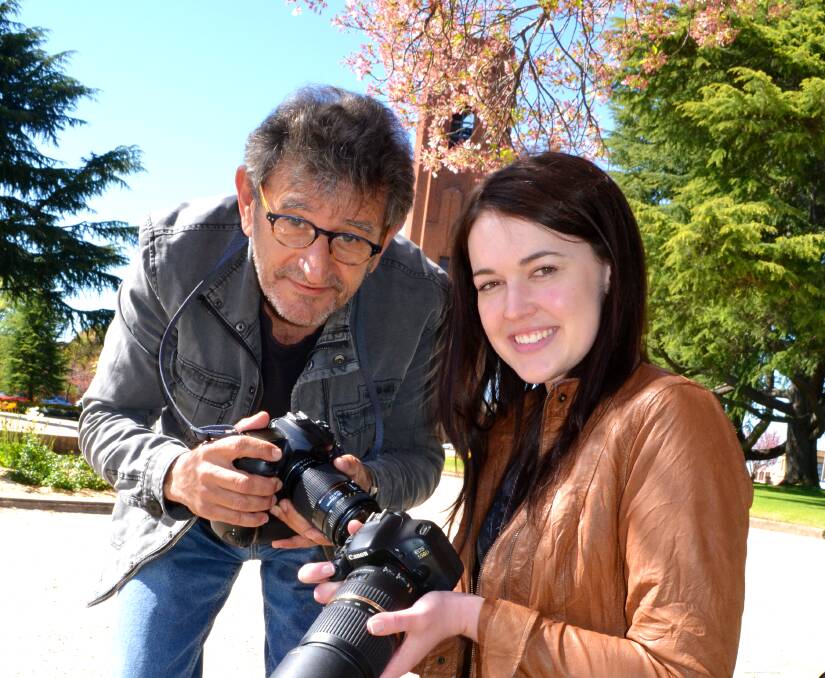 EXPERT TUITION: Rookie photographer Ashleigh Gersbach scored first place in the Western Advocate’s competition to shadow Advocate photographer Zenio Lapka at the Bathurst 1000. Photo: BRIAN WOOD 100314bwphoto