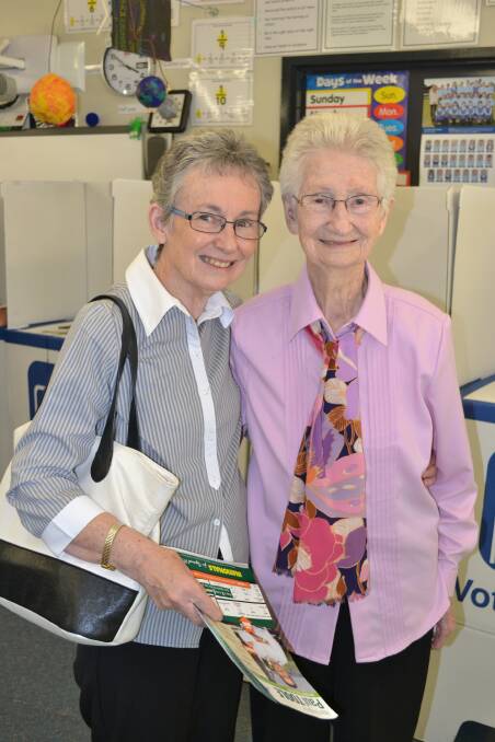 BIRTHDAY GIRL: Eunice O’Donnell (right) had to interrupt her 97th birthday party to vote at Perthville Public School on Saturday. She is pictured with her daughter Jan McGuire. Photo: NADINE MORTON 032815nmvote26