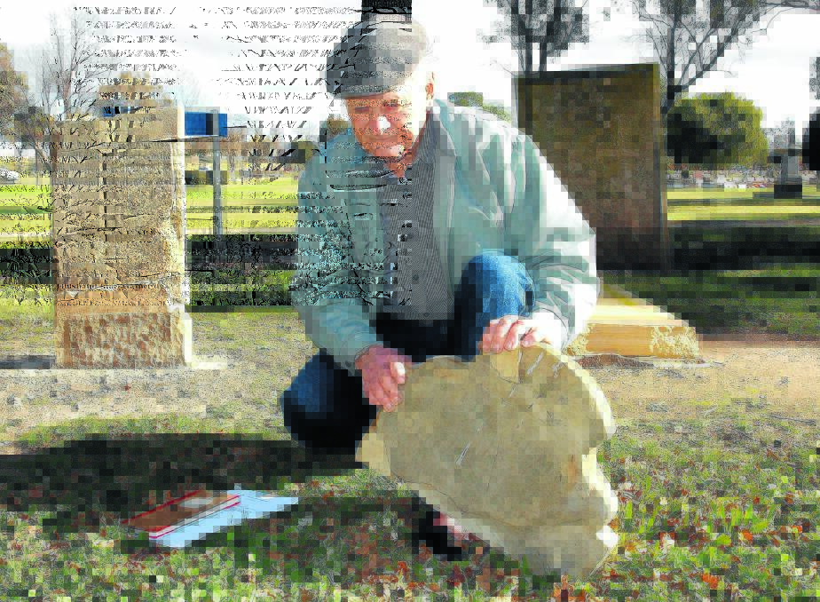 DEVASTATING: Barry Konemann with one of the headstones which police allege was destroyed by vandals last week.  062614zgrave5