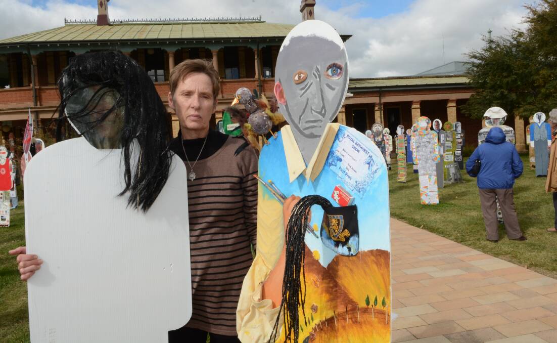 DISAPPOINTED: Peoplescape co-ordinator Jan Page with the vandalised figures. Photo: PHILL MURRAY 051215pstreet