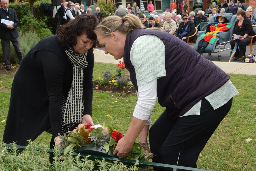 SPECIAL TRIBUTE: Macquarie Care Services volunteer Anna Roberts and carer Tine Pederson laid a wreath during their Anzac Day service on Wednesday. Photo: PHILL MURRAY 042215panzac7