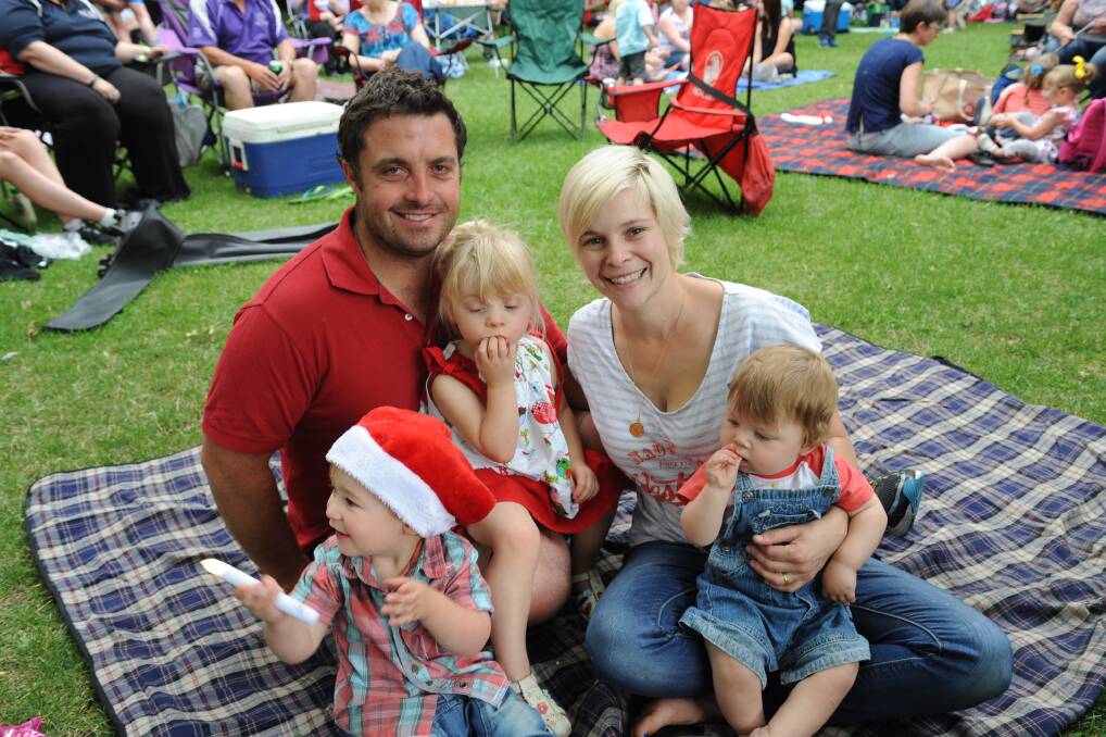 PERFECT NIGHT IN THE PARK: Brenton and Kristina Ivers and their children Ruby, 3, and Logan, 11 months  and Cody Whalan, 2, enjoyed Carols by Candlelight in Machattie Park. Photo: CLAIRE LEWIS 141214carol
