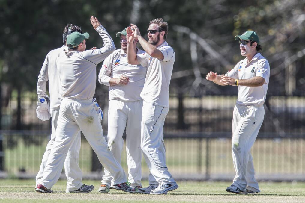 YOU BEAUTY: Bathurst cricket product Blake Dean is congratulated by his Weston Creek Molonglo team-mates after one of his 10 wickets in the grand final win over Wests. Photo: MATT BEDFORD 032415blakedean