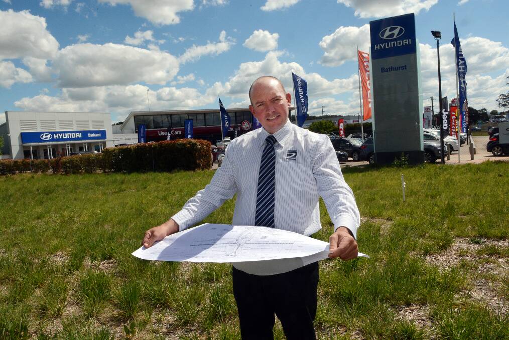 ROOM TO GROW: Bathurst Holden dealer principal Greg Brabham looks over plans for extensions to their showroom. Photo: PHILL MURRAY 101714pbxholden