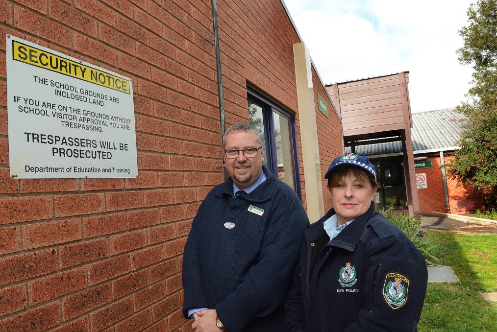 STAY AWAY: Kelso Public School principal Lance Cooper and Senior Constable Sue Rose are reminding people that school grounds will be a no-go zone during the coming holidays. Photo: PHILL MURRAY 062514pschool