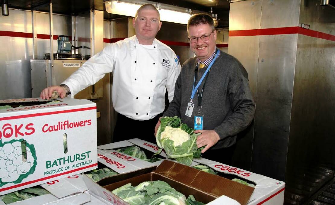 SETTING SAIL: P&O Cruises corporate executive chef Uwe Stiefel, right, and Pacific Jewel executive chef Brent Bonnette on board the Pacific Jewel with vegetables produced by Bathurst’s Michael Cook at Cook’s Cauliflowers. 060914COOK